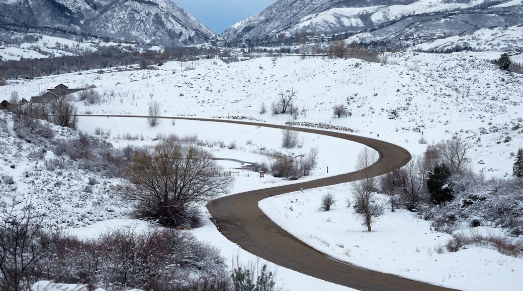 Curves of Silver Leaf Drive in Mountain Green, Utah stand out in the snow. Weber Canyon and I-84 are in the background.