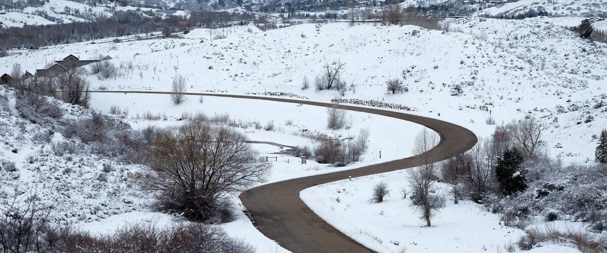 Curves of Silver Leaf Drive in Mountain Green, Utah stand out in the snow. Weber Canyon and I-84 are in the background.