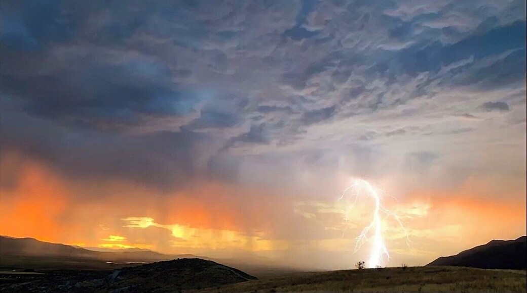 I caught this photo in the hills around Santaquin, Utah. I was just recording a video of the sunset when out of nowhere lightning started striking! #adventure