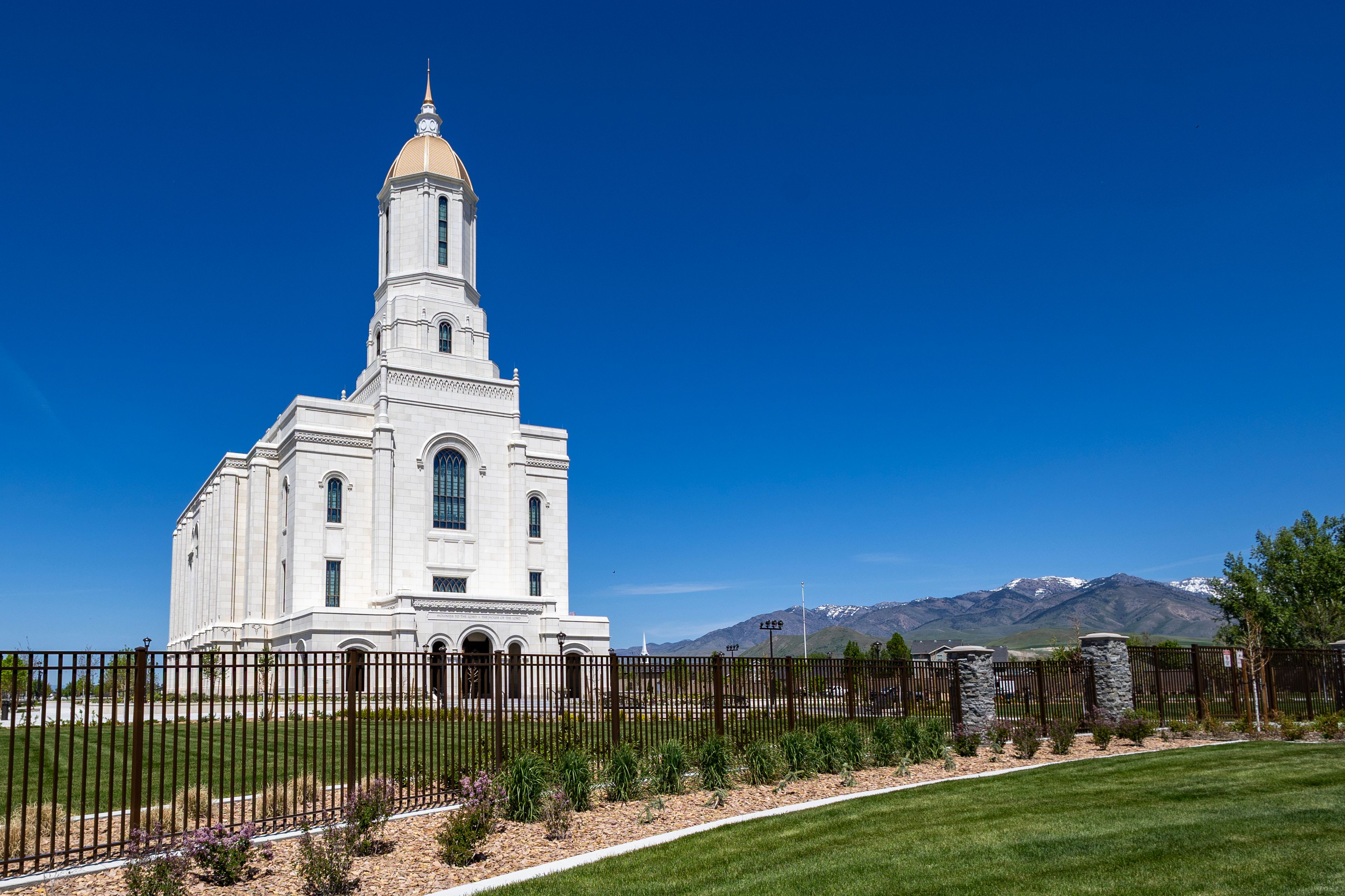 Smithfield Utah Temple Exterior LDS Church with Mountains Blue Sky and Landscaped Gardens