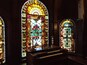 The organ and stained glass windows on the landing between the first and second floors.