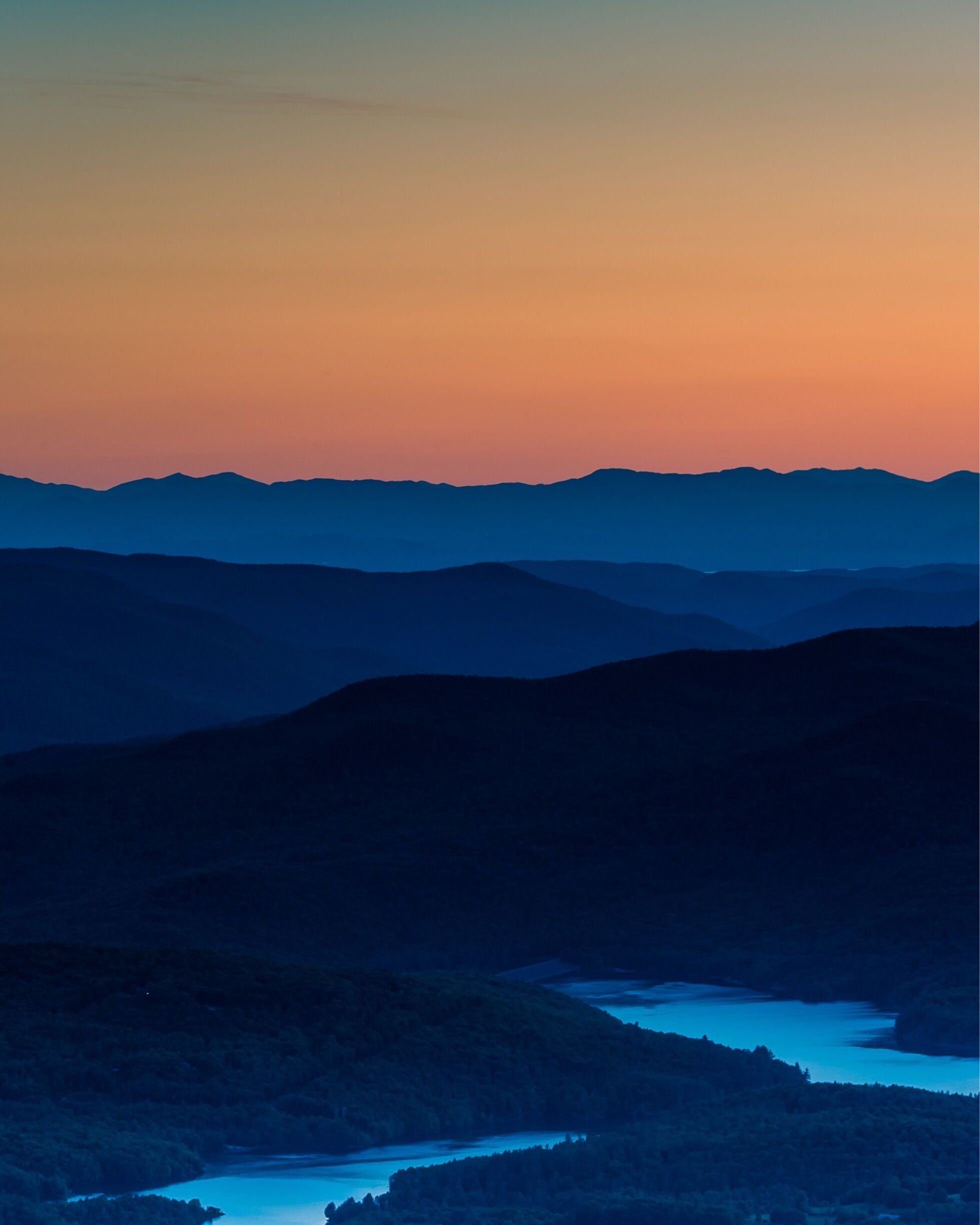 A mountainous landscape with a river at the base.