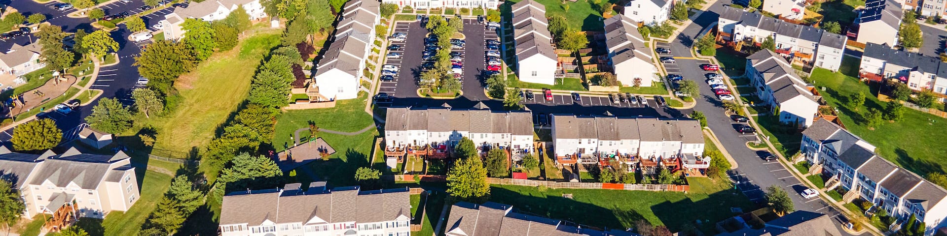 Aerial views of residential area, roads, parks and shopping areas.