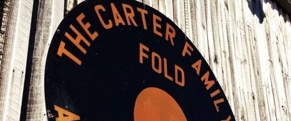 A circular sign with text reading "The Carter Family Fold Honoring A.P. Sara & Maybelle."