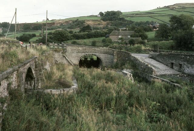 Bugsworth Basin. The restoration of this historically important canal basin complex took place over many years and was plagued by problems with leaks in the canal bed before finally being reopened. In this 1981 view work on many of the remaining structures was well advanced although plenty remained to be done before the basin could be rewatered. Compare this picture with a similar view today 572172.