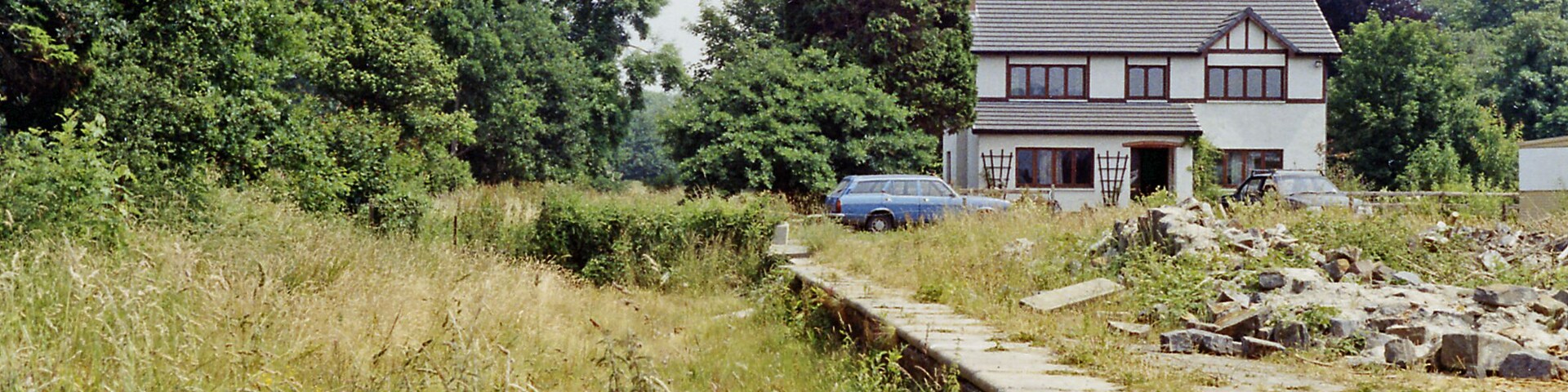 Abergwili station (remains). View eastward, towards Llandilo: ex-LNWR Llandilo - Carmarthen branch, all closed 9/9/63. The house appears to be newer.