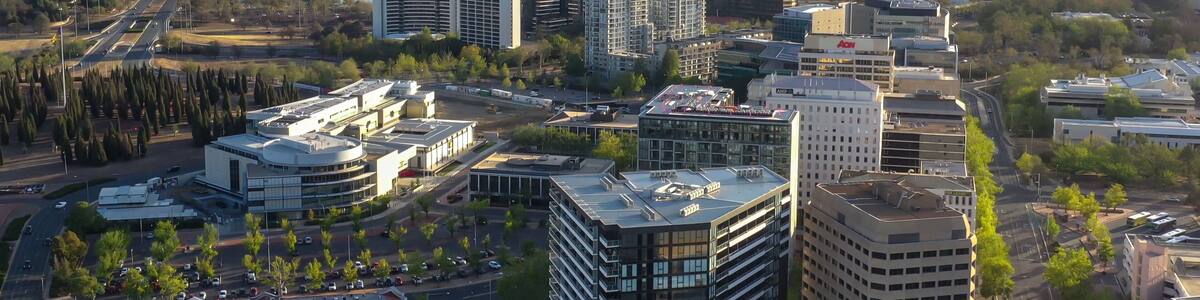 Aerial view of Canberra City, the capital of Australia, looking south toward Lake Burley Griffin and Commonwealth Bridge on a sunny afternoon