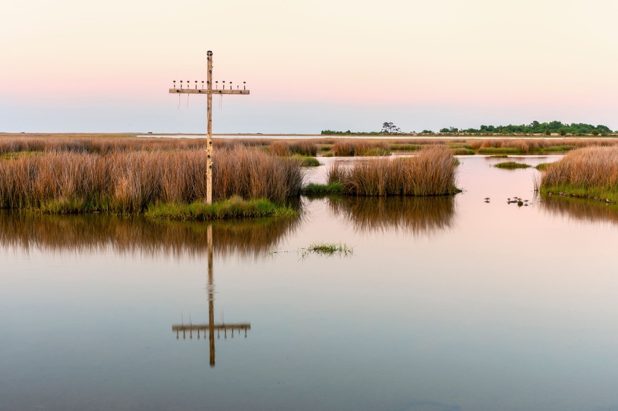 Cross standing in marsh of Chesapeake Bay, Poquoson, Virginia, USA