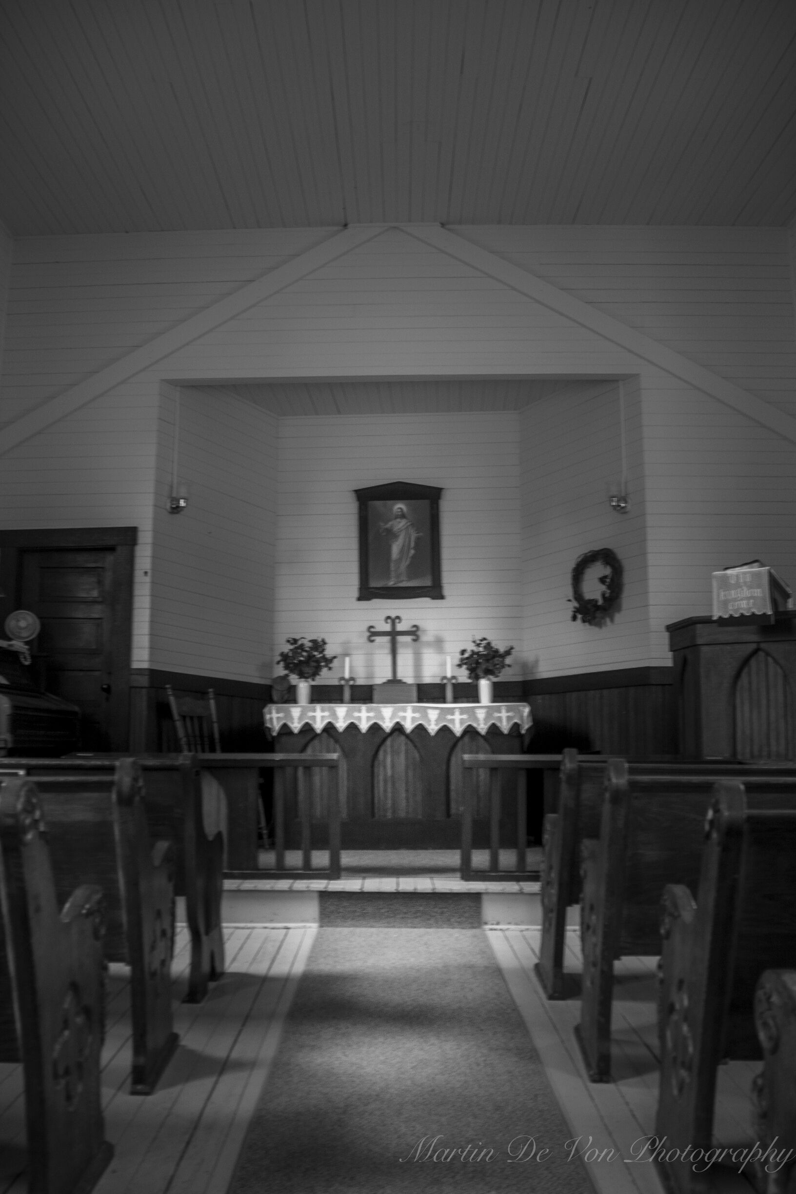Lettered prominently on the steeple of the landmark Elbe Lutheran Church is "Ev. Luth. KIRCHE" (Evangelische Lutherische Kirche), a reminder of the founders' German origins.

This tiny (18-by-24 foot) church sits on its original location in the beautiful foothills west of Mount Rainier.  The town of Elbe, Washington, has a rich German heritage and bears the name of the founders' origin, the Elbe River valley near Hamburg, Germany. As it has since 1906, the church signifies peace
and tranquility to residents and tourists alike.
 
Beginning in 1893, worshipers met in homes and the town hall until the church was constructed in 1906. A founder of the town, Heinrich Lutkens, donated the land and material for the church. Pastor Karl Kilian designed this simple yet pleasing building, and the townspeople built it themselves. Pastor Kilian served his Elbe flock from 1906 to 1933.

Forged by the town's first blacksmith, a 4-foot iron cross tops the 46-foot steeple, which houses the first bell.  The church still features its original altar and elevated pulpit as well as one of the hand-carved pews. The original Farrand & Votey bellows organ is still used for worship and weddings. Offerings are taken with the traditional "Klingelbeutel" (a small red-velvet bag with a bell on it.)

Dr. Ervin E. Krebs conducted the research that led to the church's placement on the National Register of Historic Places in 1976.

Experience the simple charm of this tiny church where "time meets eternity." Worship services are held at 2:30 p.m. on the third Sunday of the month from March through November. Please join us if you are in the area. Open during the summer for tourists, the church is also a popular place for weddings.

Volunteers care for the Elbe Ev. Kirche, relying on
donations to maintain this historic church building.
