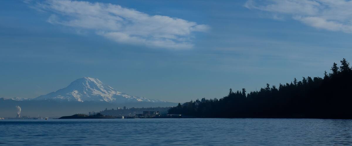 Panorama shot of Mt Rainier and Tacoma's Point Defiance Park as seen on a boat in the Narrows