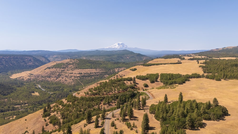 Mount Adams volcano, Oregon, USA from scenic road Glenwood Highway, dry yellow grass and forest. Aerial view