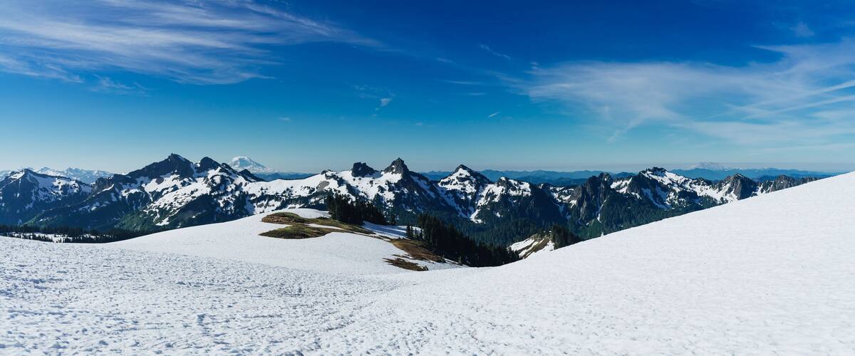 A snow-covered mountain range with clear blue skies.