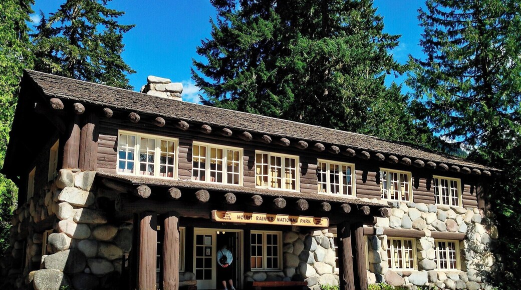 When Mount Rainier National Park was established in 1899 the park headquarters were located at the site of James Longmire's homestead and mineral springs resort. Over the subsequent decades a number of architecturally significant buildings were constructed, including the Administration Building pictured here.
What sets this building apart is the use of glacial boulders to form much of the first story walls. Massive log beams and log-siding complete the structure, while a large fireplace dominates the lobby. Overall, the building appears largely the same as it did when built in the late 1920s.
Today the building serves as a visitor information center.
#Architecture