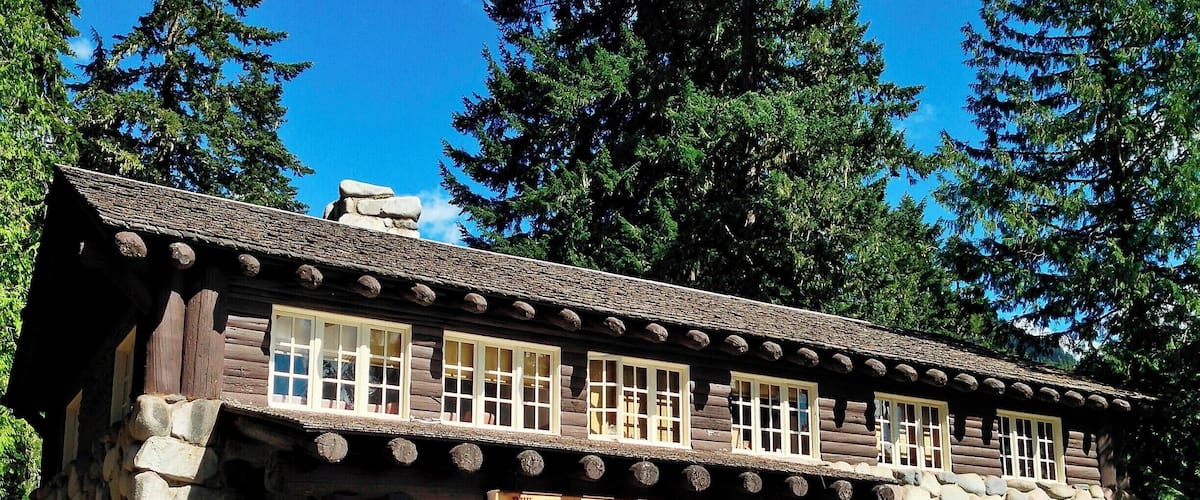 When Mount Rainier National Park was established in 1899 the park headquarters were located at the site of James Longmire's homestead and mineral springs resort. Over the subsequent decades a number of architecturally significant buildings were constructed, including the Administration Building pictured here.
What sets this building apart is the use of glacial boulders to form much of the first story walls. Massive log beams and log-siding complete the structure, while a large fireplace dominates the lobby. Overall, the building appears largely the same as it did when built in the late 1920s.
Today the building serves as a visitor information center.
#Architecture