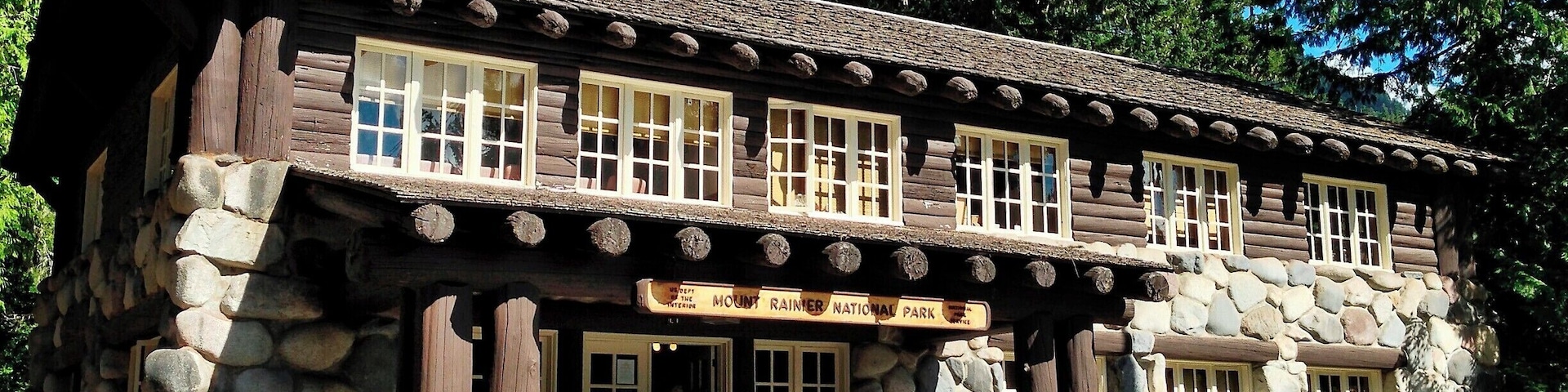 When Mount Rainier National Park was established in 1899 the park headquarters were located at the site of James Longmire's homestead and mineral springs resort. Over the subsequent decades a number of architecturally significant buildings were constructed, including the Administration Building pictured here.
What sets this building apart is the use of glacial boulders to form much of the first story walls. Massive log beams and log-siding complete the structure, while a large fireplace dominates the lobby. Overall, the building appears largely the same as it did when built in the late 1920s.
Today the building serves as a visitor information center.
#Architecture