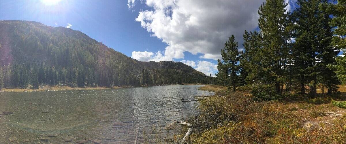 A mountain lake surrounded by dense forest.