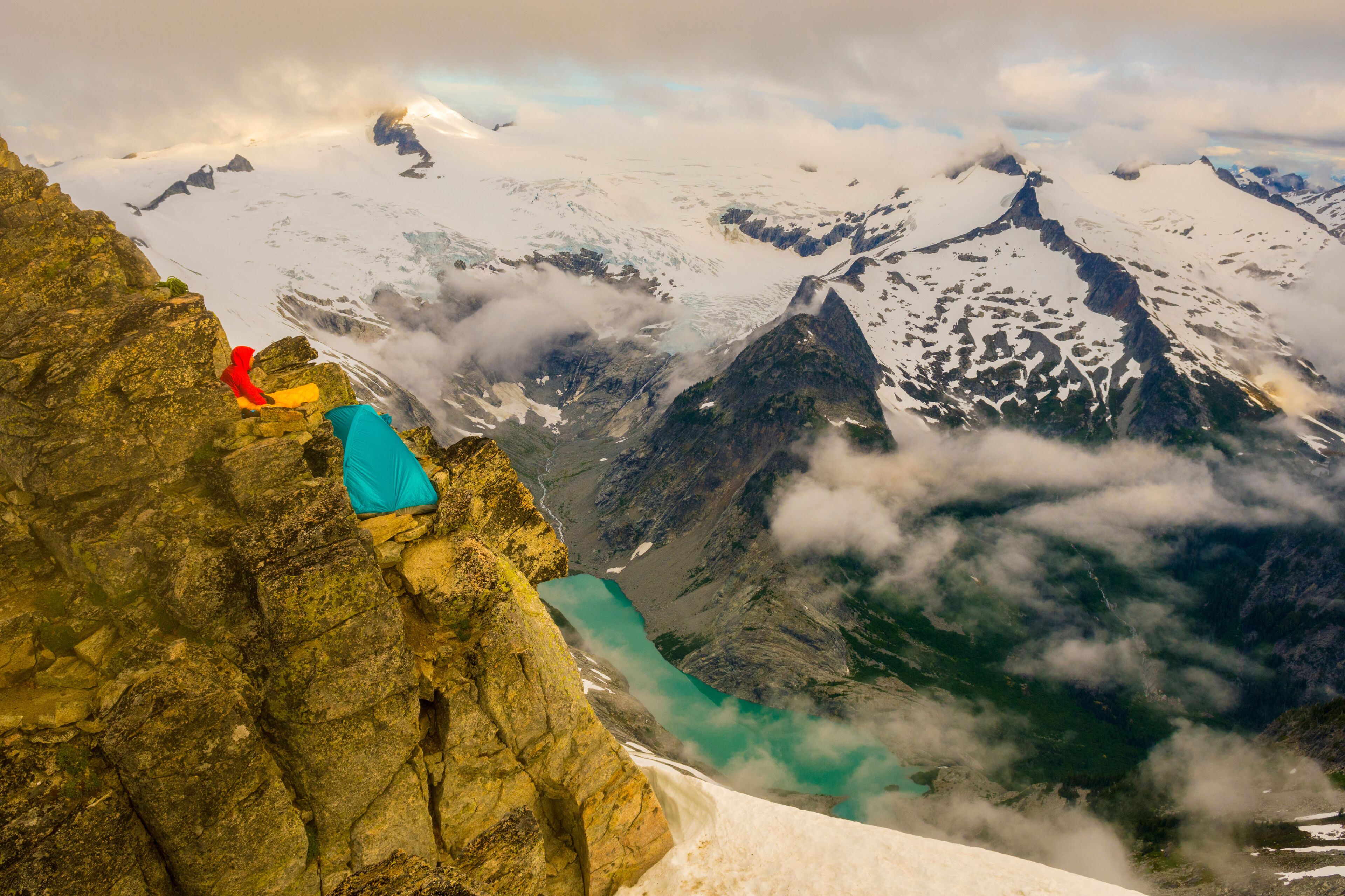 Man and camping tent at Mount Forbidden, North Cascades National Park,â€ Marblemount, Washington State, USA