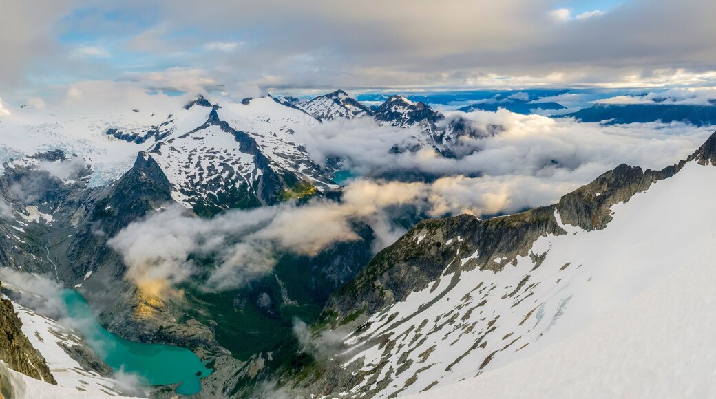 Panorama of man camping on Forbidden Peak in Washington