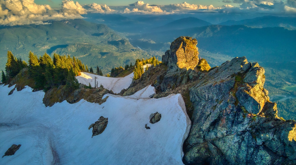 Aerial view of a snowy rocky hill in the daytime