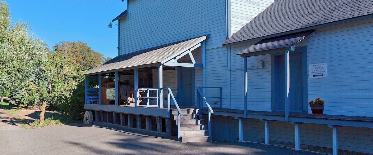 This grist mill was built in the 1880s and operated as a feed and flour mill until 1946.  The area was first developed ten years earlier when James Mills dug a 2-mile (3.2km) ditch from the Yakima River to create a log pond and power his sawmill.  The grist mill was powered by the same outflow, and with the arrival of the Northern Pacific Railroad in 1886 and Milwaukee Road in 1908, the mill was able to sell it's products nationwide.
In addition to the sawmill and grist mill the owners added an ice pond in 1889 to service the Northern Pacific.  Between this pond, and the larger Sprague Lake, over 40,000 tons of ice could be packed into hundreds of refrigerated cars each year.  Using sawdust to insulate the ice, they were able to supply the railroads all the way through to the end of summer.
Today the grist mill serves as a small museum and a reminder of human ingenuity and capitalism. The turn-of-the-century equipment inside has earned it a place on the National Register of Historic Places.
