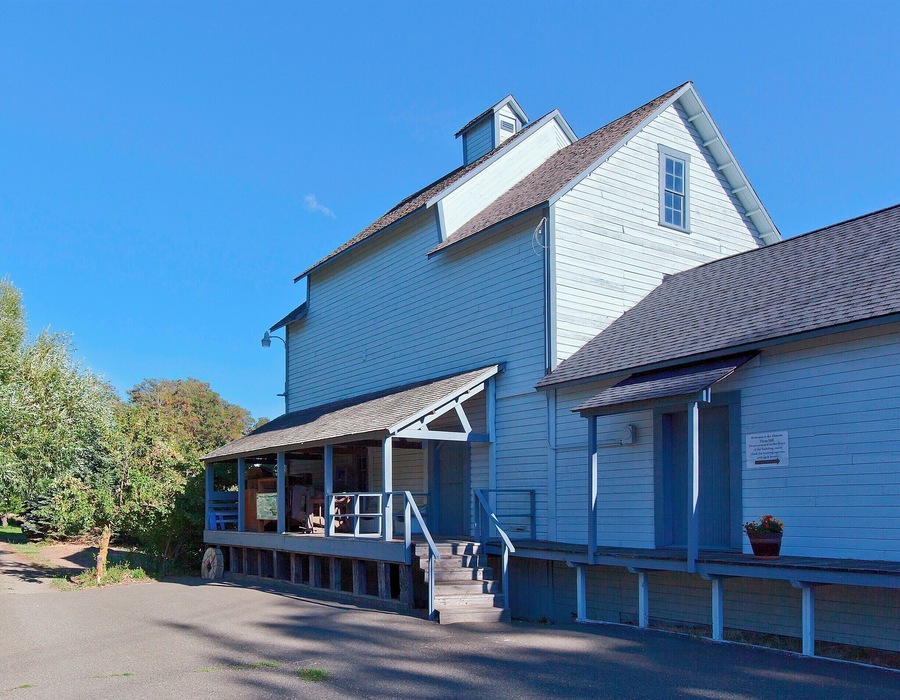 This grist mill was built in the 1880s and operated as a feed and flour mill until 1946. The area was first developed ten years earlier when James Mills dug a 2-mile (3.2km) ditch from the Yakima River to create a log pond and power his sawmill. The grist mill was powered by the same outflow, and with the arrival of the Northern Pacific Railroad in 1886 and Milwaukee Road in 1908, the mill was able to sell it's products nationwide.
In addition to the sawmill and grist mill the owners added an ice pond in 1889 to service the Northern Pacific. Between this pond, and the larger Sprague Lake, over 40,000 tons of ice could be packed into hundreds of refrigerated cars each year. Using sawdust to insulate the ice, they were able to supply the railroads all the way through to the end of summer.
Today the grist mill serves as a small museum and a reminder of human ingenuity and capitalism. The turn-of-the-century equipment inside has earned it a place on the National Register of Historic Places.