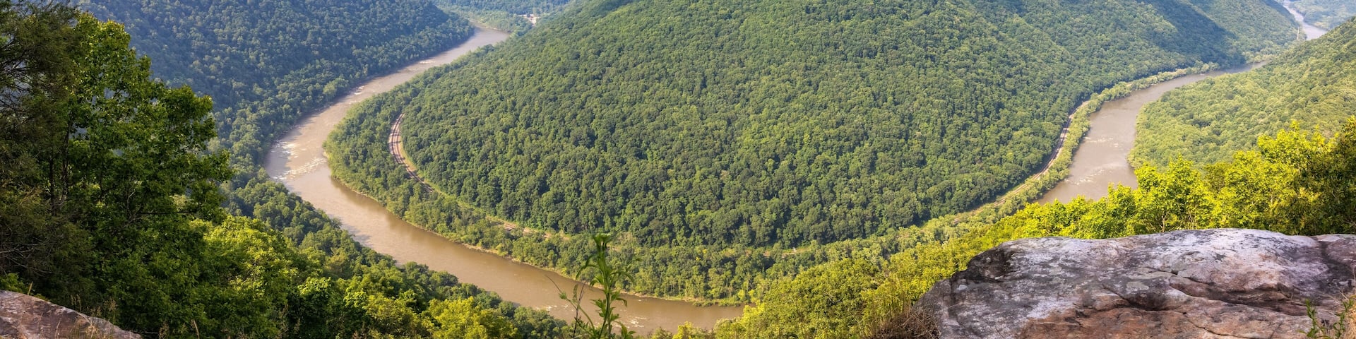New River flowing through the New River Gorge National Park with With White Water Rafts on Rapids Around Central Island