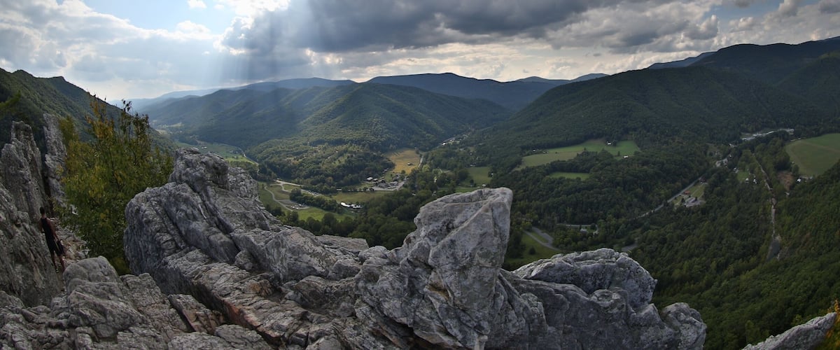 A mountainous landscape with rocky outcrops and a valley below.