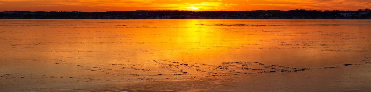 sunset over the ice on lake