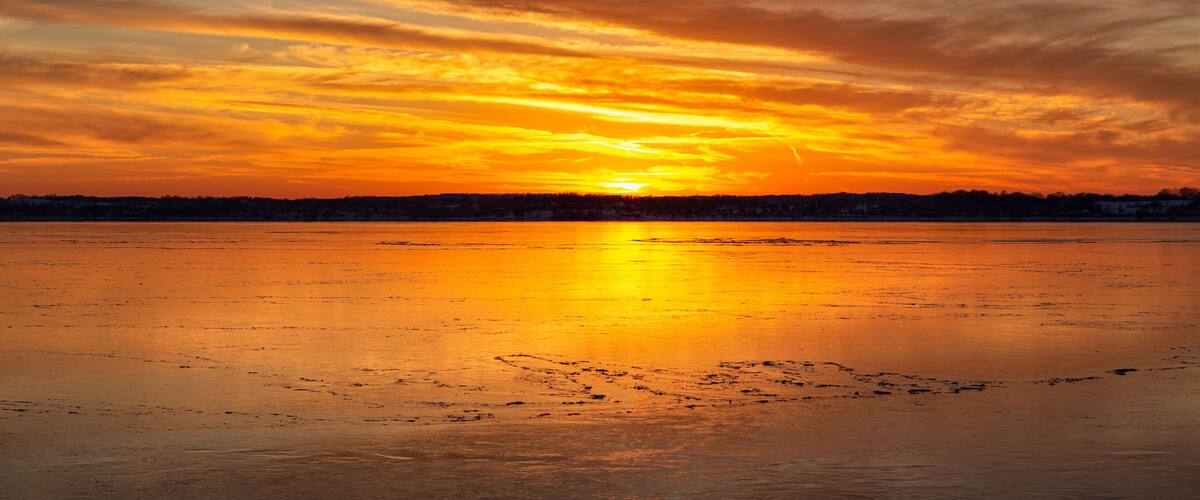 sunset over the ice on lake