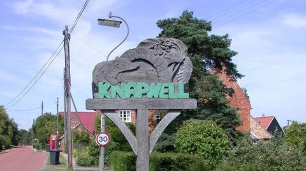 Knapwell Village Sign The carved wooden sign shows a well head, badgers, oxlips and the date 1895, whose significance eludes me.
