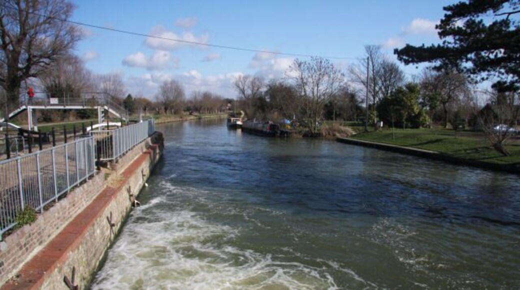 River Cam at Baits Bite Lock The rushing water is spilling from the weir, looking downstream from the footbridge across the river.