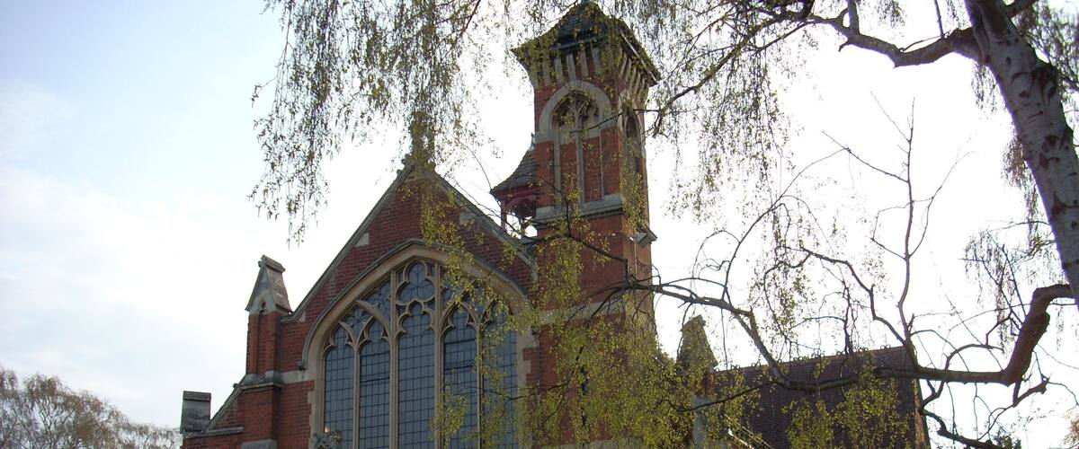 A historic church with a prominent steeple and large arched windows.