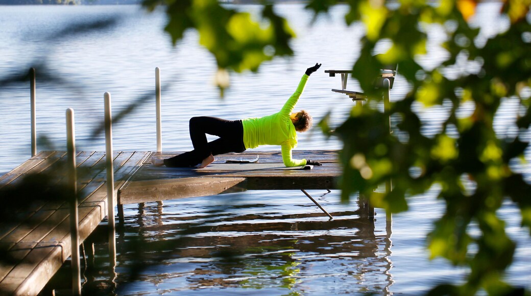 A woman does stretches on a pier on South Twin Lake in Conover, Wisconsin