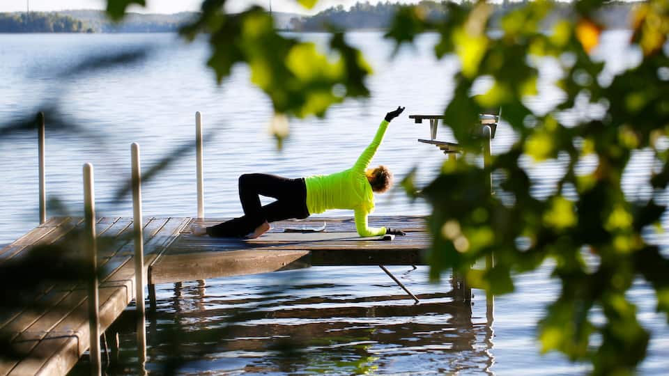 A woman does stretches on a pier on South Twin Lake in Conover, Wisconsin