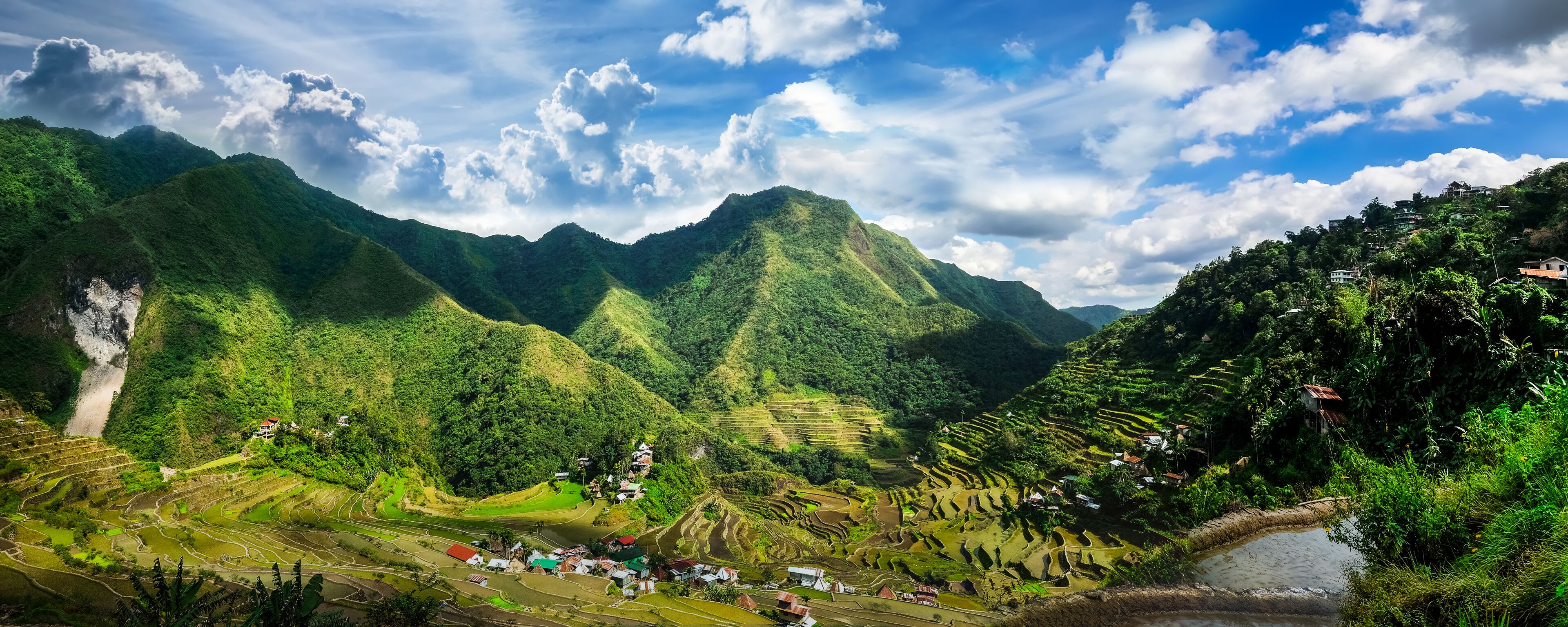 Amazing panorama view of rice terraces fields in Ifugao province mountains under cloudy blue sky. Banaue, Philippines UNESCO heritage