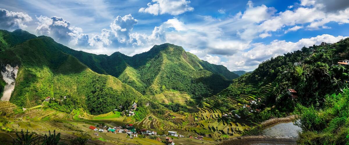 Amazing panorama view of rice terraces fields in Ifugao province mountains under cloudy blue sky. Banaue, Philippines UNESCO heritage
