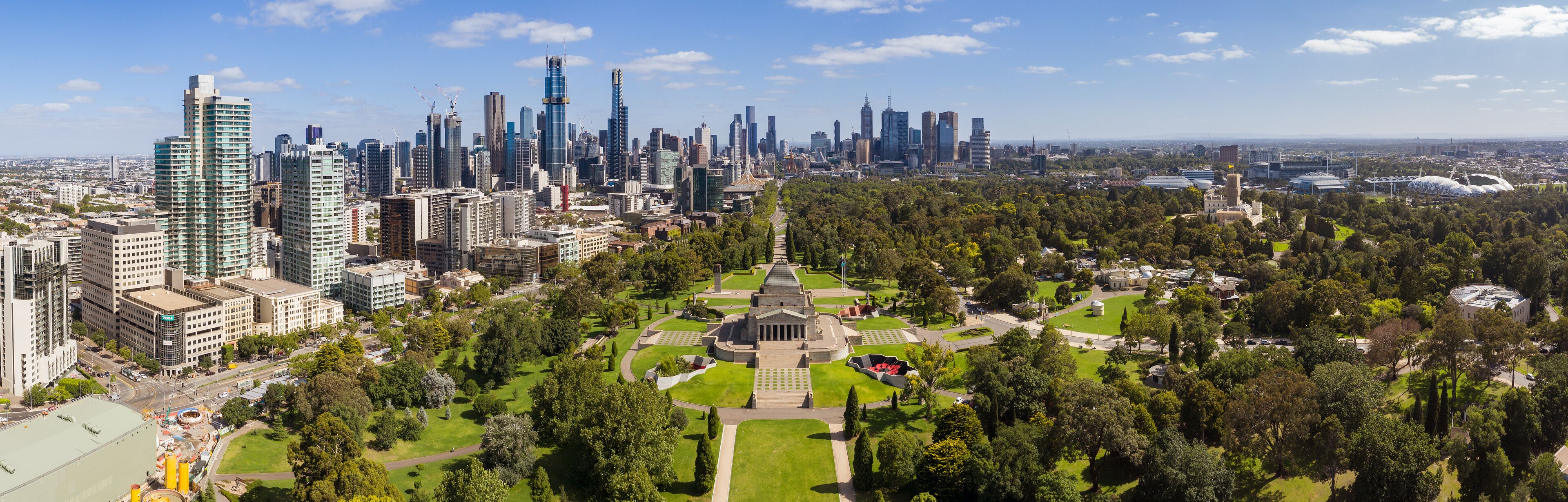 Aerial panoramic image of the city of Melbourne and the Shrine of Rememberance  through to the AAMI Stadium from the Botanic Gardens
