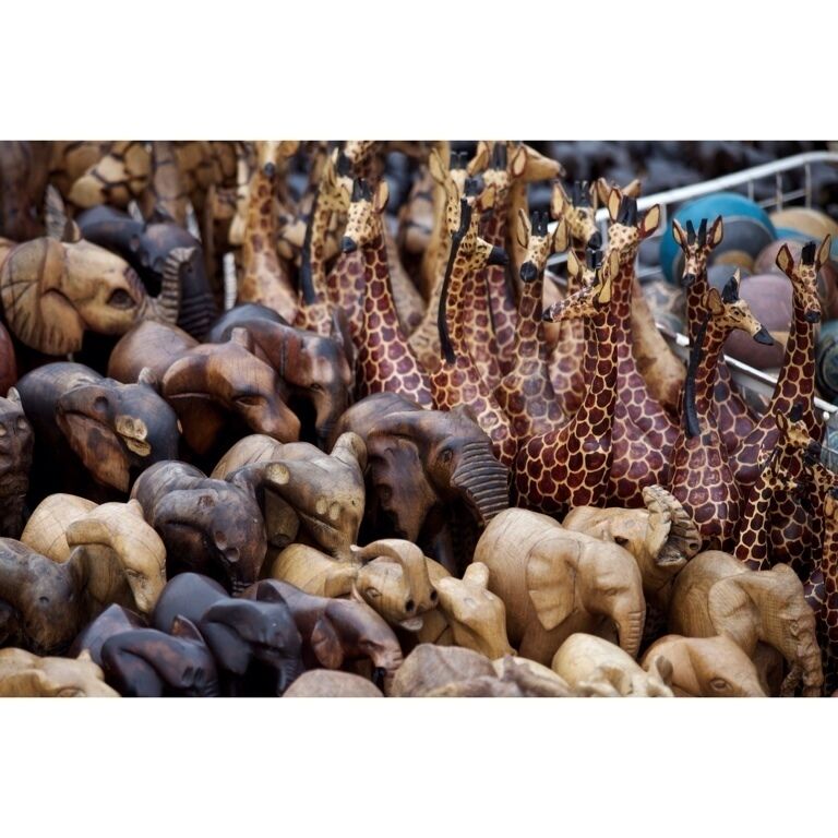 A collection of wooden animal sculptures, including giraffes and elephants.