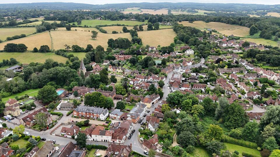 A rural village with houses, roads, and fields.