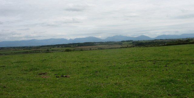 View south across farmlands from Bachau The northern flank of Snowdonia forms the background.