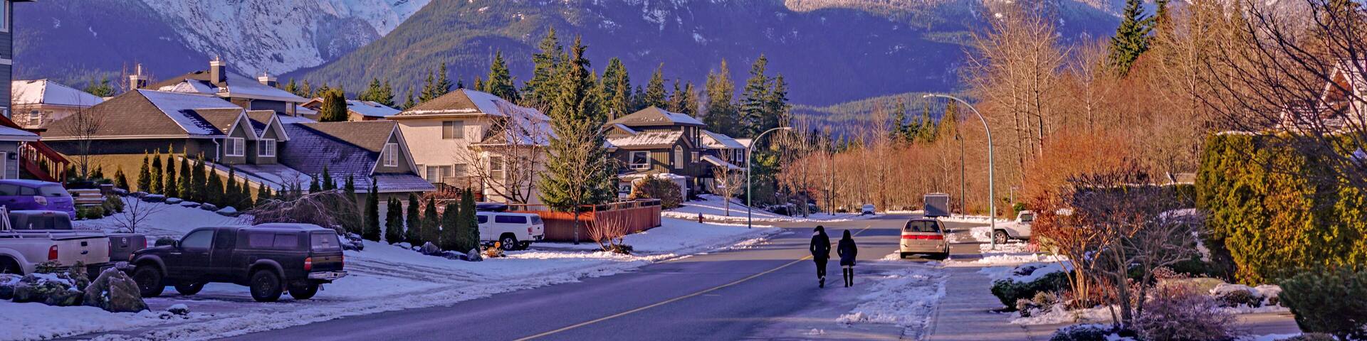 Winter walking in Garibaldi Highlands, Squamish, BC, with Garibaldi Mountain in background.