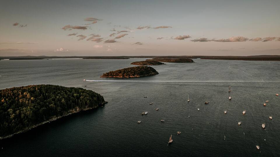 A large body of water with several small islands and boats.