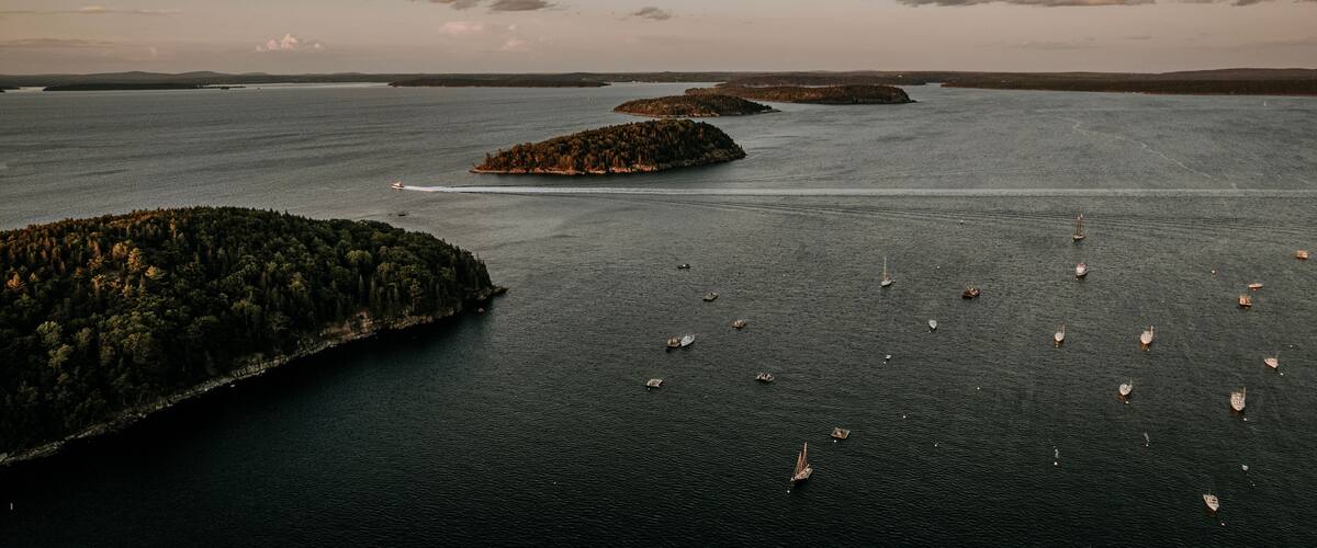 A large body of water with several small islands and boats.