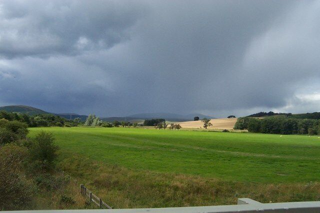 Field with mountains in background Taken from A697 road towards the wet Cheviot Hills.