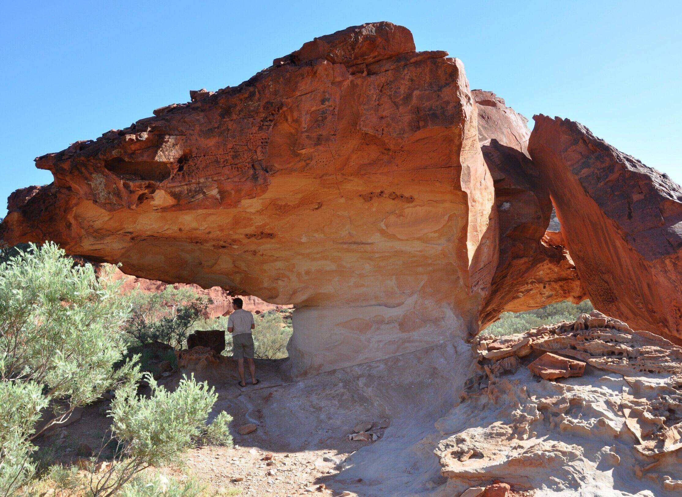 A large rock formation with a natural arch.