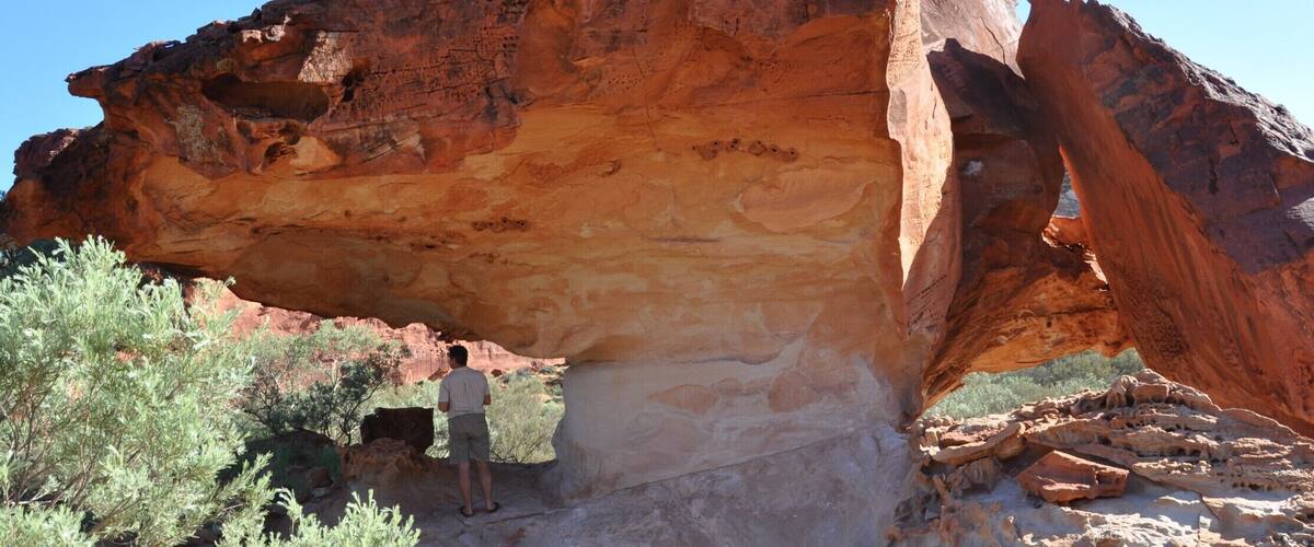 A large rock formation with a natural arch.
