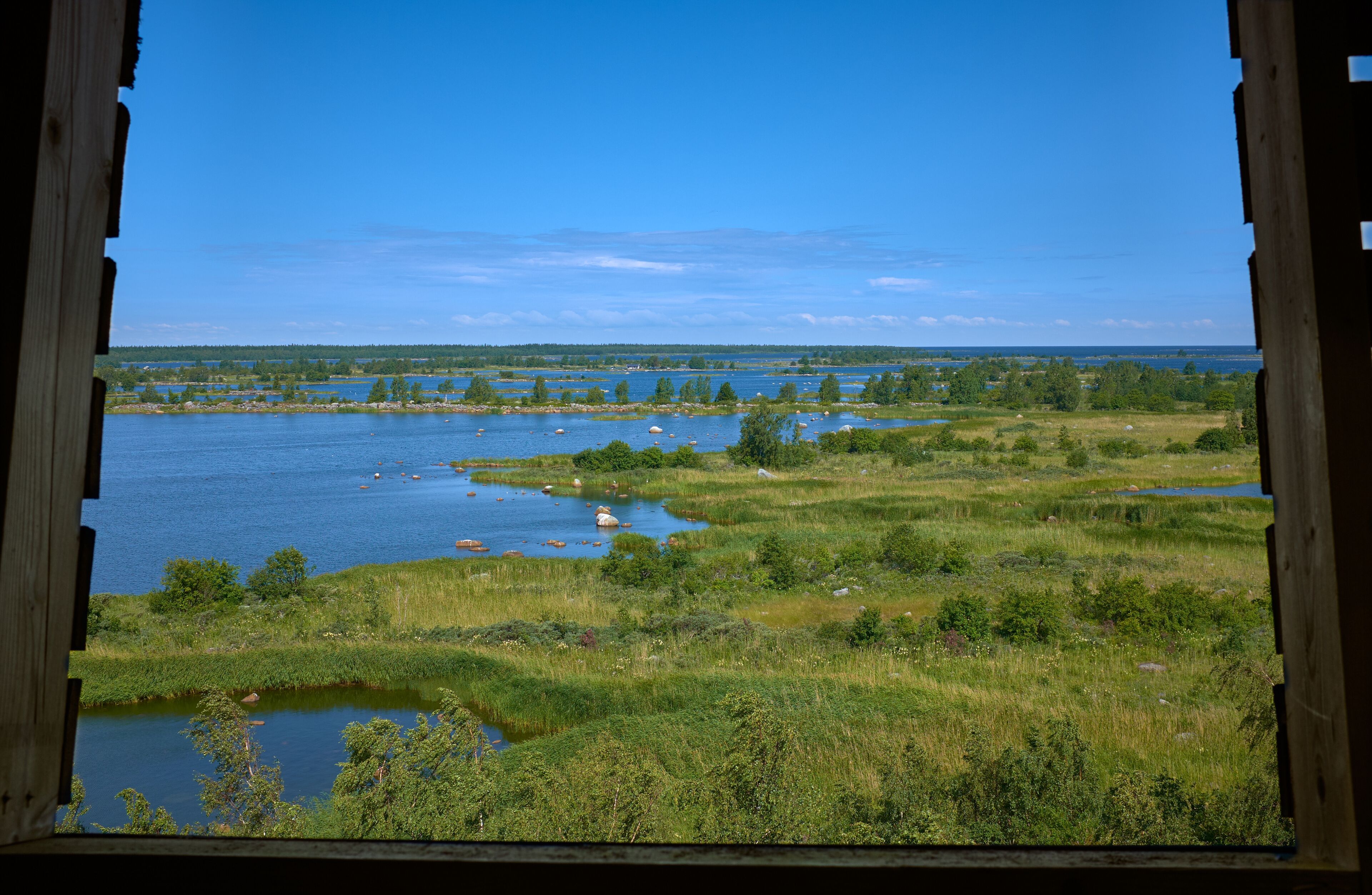 Summer landscape from wooden window in FInland, Mustasaari.