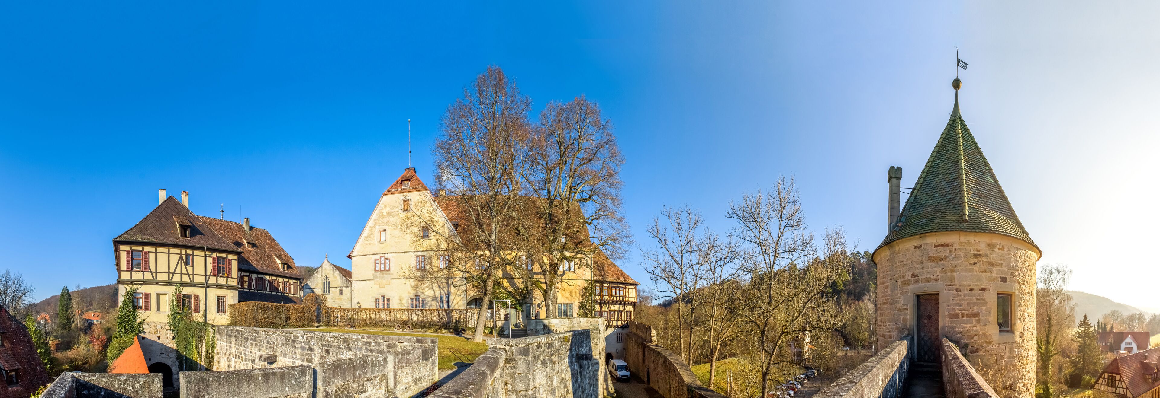 A historic town with a prominent church, a castle, and a stone tower.