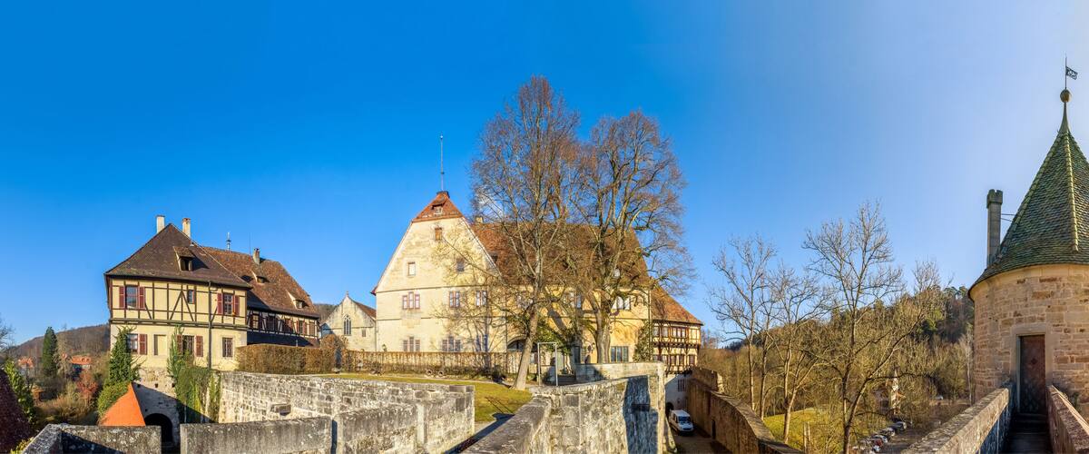 A historic town with a prominent church, a castle, and a stone tower.