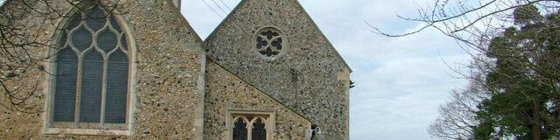 Creeting St. Mary church from the drive. The building described as 1107207 is on the right of the drive. The complicated shape of the church presumably reflects the 1801 modifications described in the caption to 1107204.